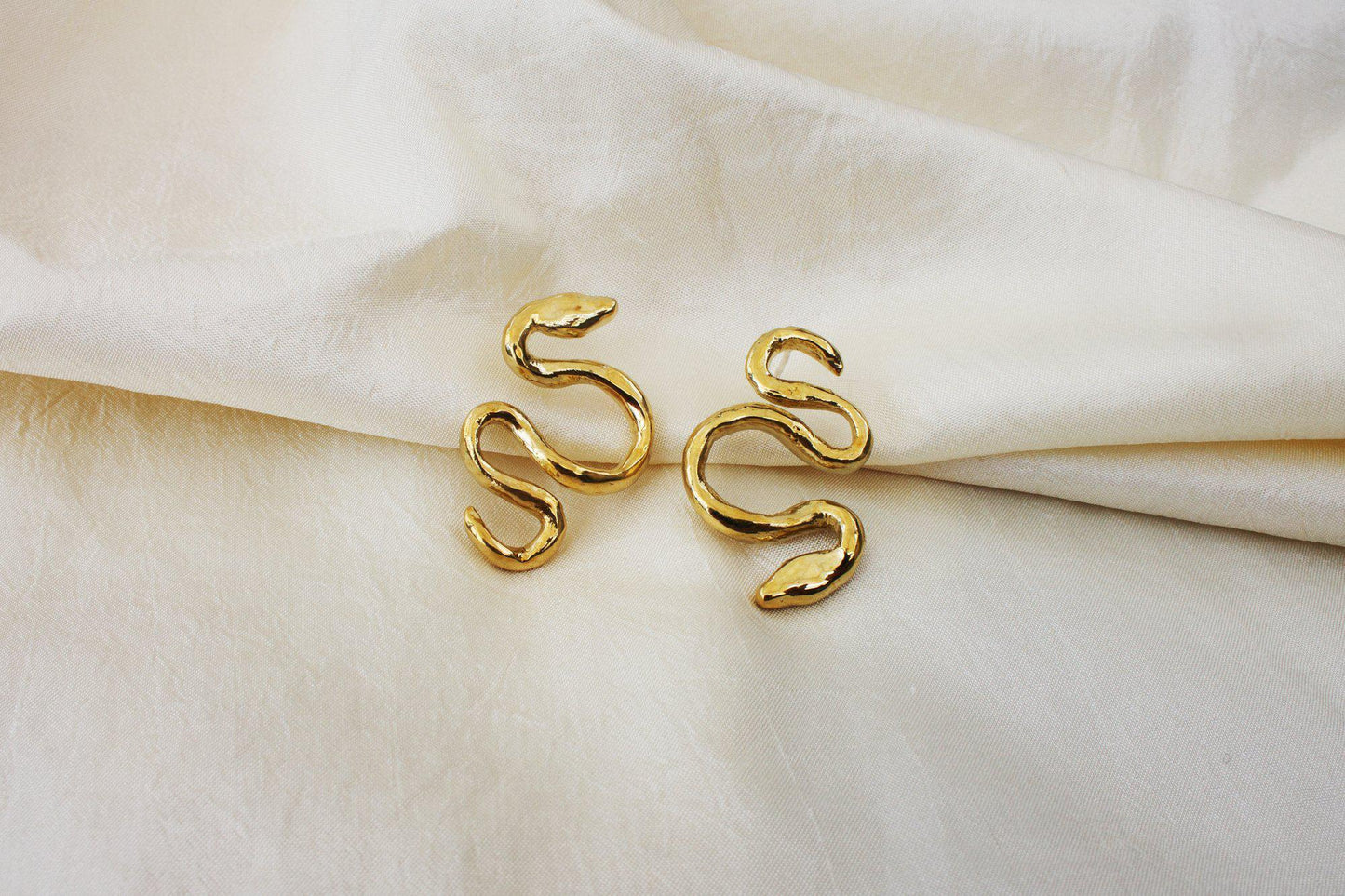 An often maligned species, we find beauty in the powerful serpent. Asymmetrical snake earrings available in brass and sterling silver. All Dea Dia pieces are proudly designed and handmade in Downtown Los Angeles.