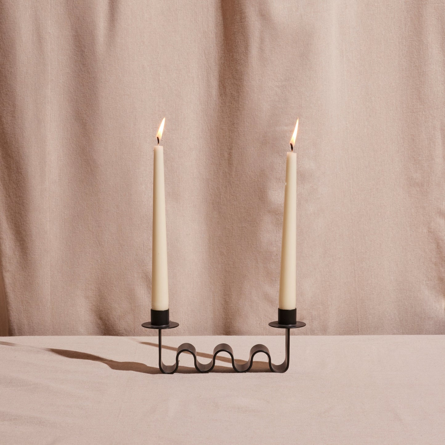 Wavy Black metal candle holder for two taper holders.
Designed by Diego Olivero.
