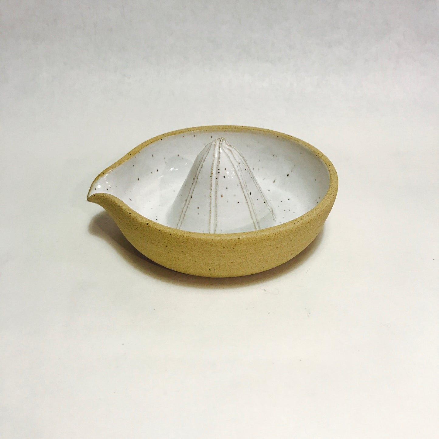 For all your juicing needs. Hand thrown with a raw, unglazed exterior and speckled interior. Each item is made individually in Olympia, Washington.