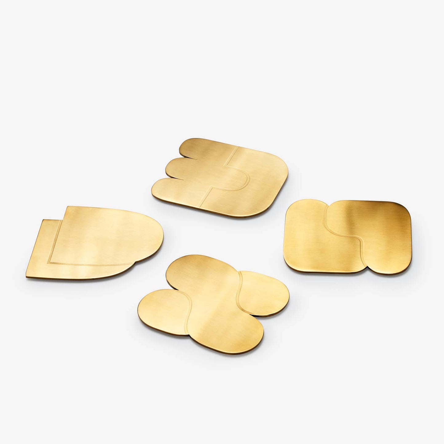 areaware together coasters / Set of four brass-plated coasters uses abstract, interlocking shapes to signify connection and togetherness. The weightiness of the brass ensures none of those sticking-to-your-cup situations when picked up, & designed to protect your surfaces from watermarks and scratches.