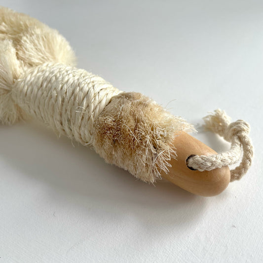 Enhance your daily skincare ritual with this stimulating body brush. Designed to be used on dry skin, its soft bristles provide gentle exfoliation as it promotes lymphatic drainage and boosts circulation. Sisal is a natural fiber from the agave sisalana plant, stronger and more durable than other natural fibers. It is resistant to bacteria, mildew, and oil.