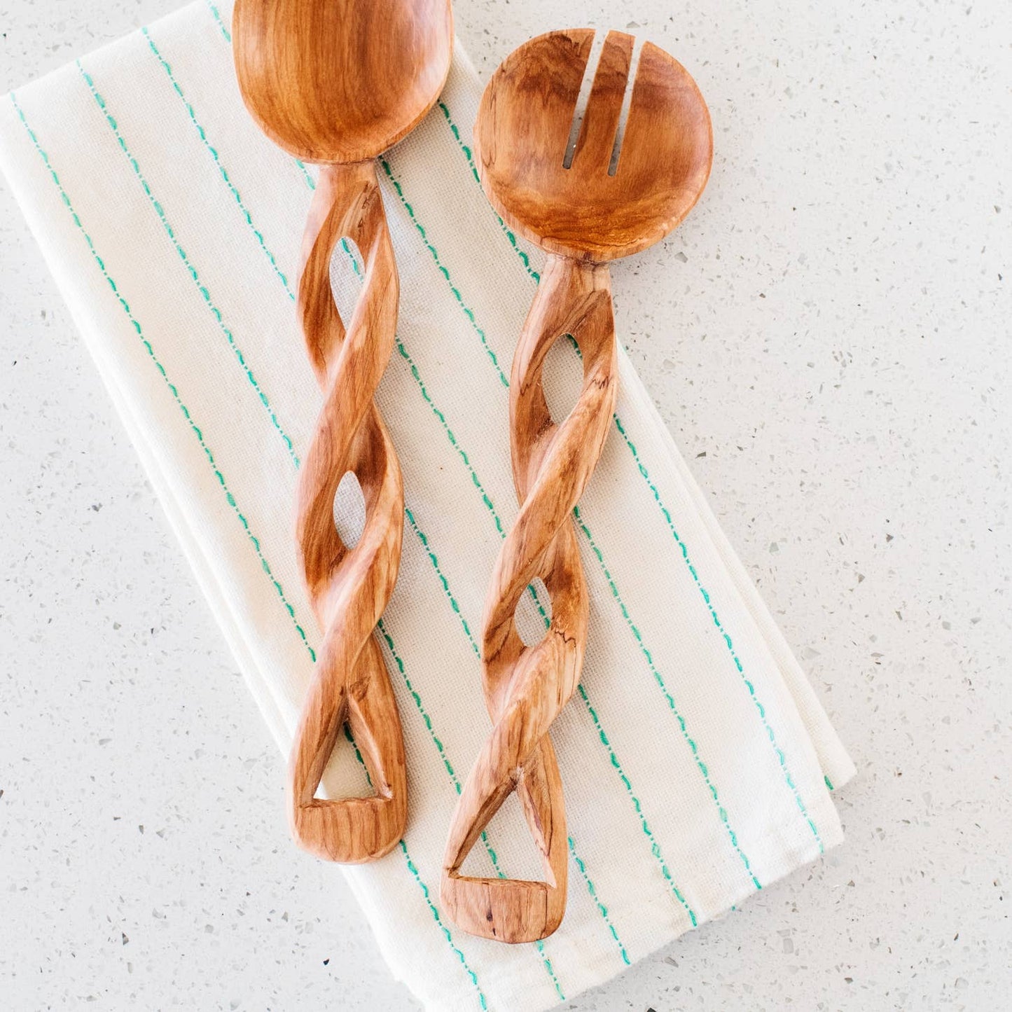 These twisted serving spoons are perfect for salads & are delicately carved from durable olive wood. Wild olivewood has a rich grain and is indigenous to East Africa. Ethically made in Kenya.