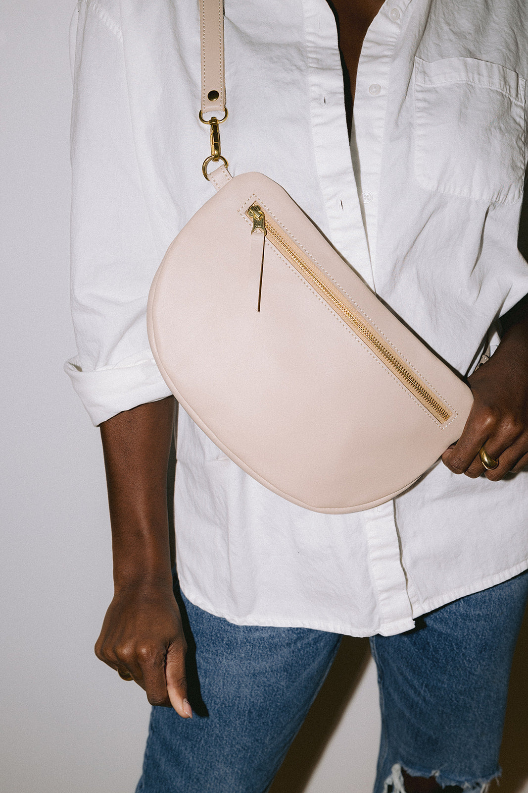 The best-selling Sling Bag is now available in a bigger size. Still sleek, lightweight, and chic, now you'll be able to add that *one* extra thing. Your large wallet, glasses case, or even a small book will fit inside the Big Sling. Fair trade and adjustable leather sling bag/fanny pack.