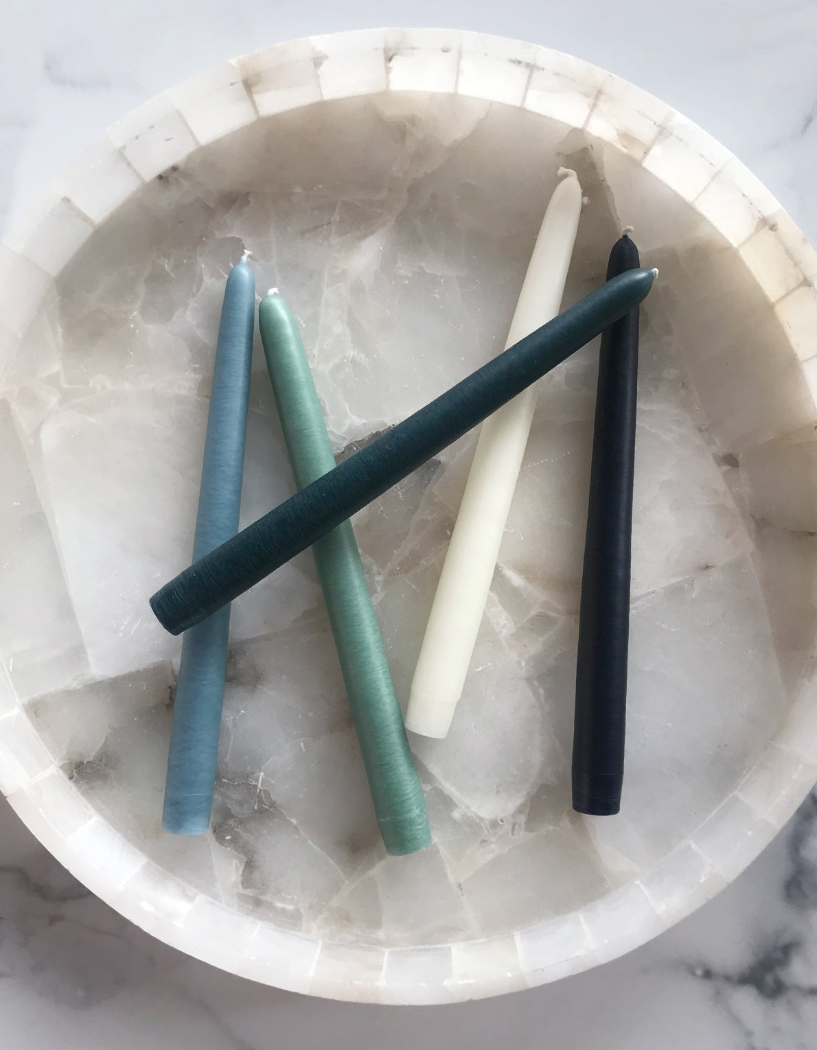 Botanica's set of five tapered candles are dipped over 20 times by hand, creating the ideal taper–dripless and smokeless–perfect for dinner parties and creating warm, homey ambiance.