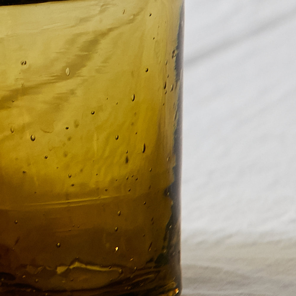 Simple and elegant, the modern glass cup is perfect to serve your favorite drinks or a little desert or even condiments. Handblown in morocco using local recycled beer bottles, giving these materials another life. These glasses are ideal for entertainment or everyday drink ware.