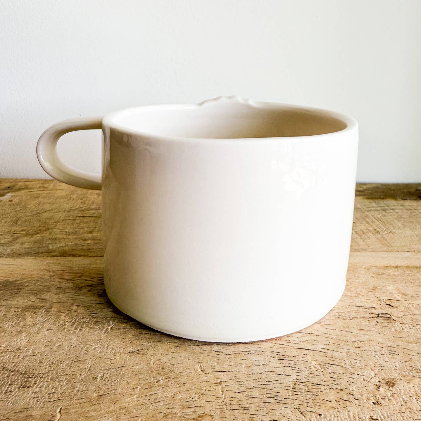 Seashell mugs are hand-thrown from fine porcelain, and feature hand drawn inlay and mother of pearl luster for a delicate and iridescent shine.