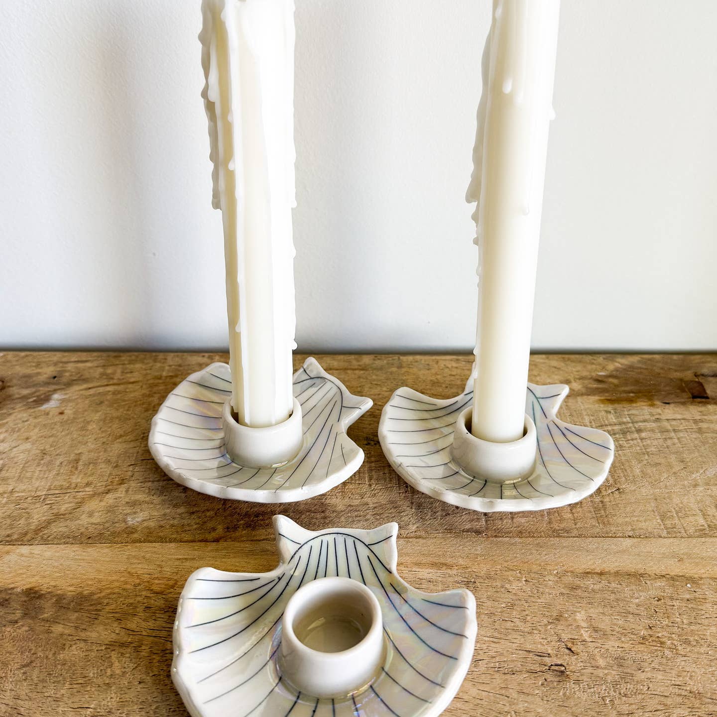 Each candle holder is hand-thrown from fine porcelain, and features hand drawn inlay and mother of pearl luster for a delicate and iridescent shine.