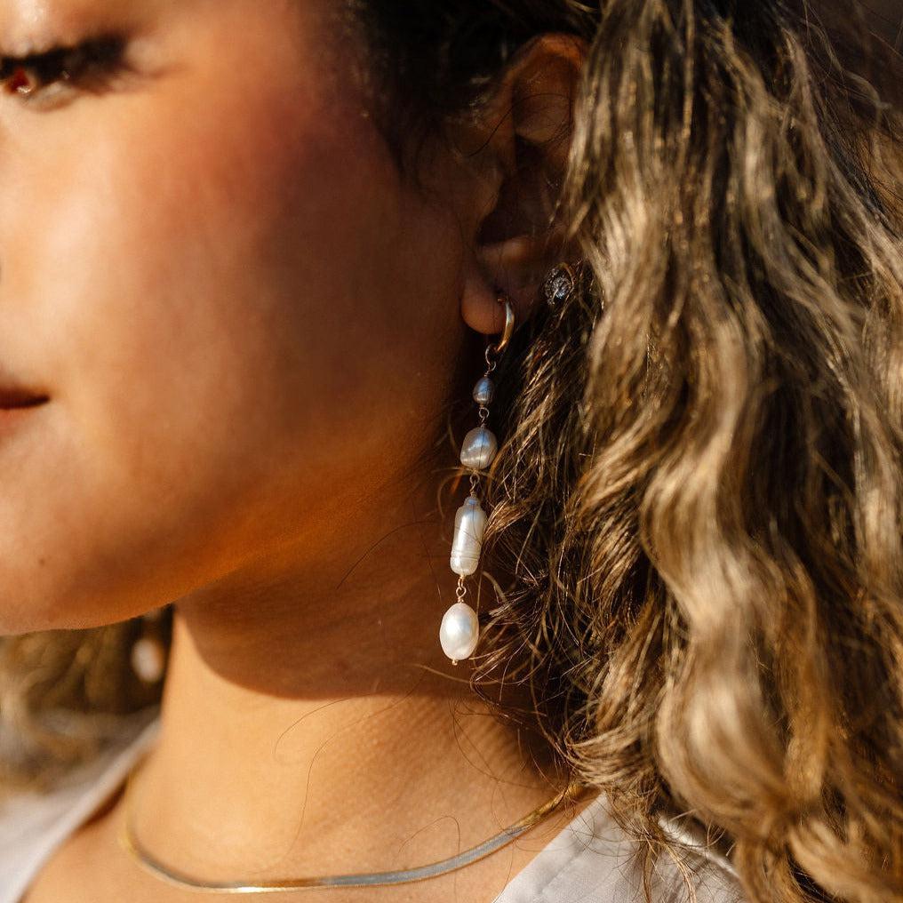 Unique and elegant, these pearl duster earrings were designed with 4 freshwater pearls in various shapes and sizes interconnected with delicate gold fill wire. All Dea Dia pieces are proudly designed and handmade in Downtown Los Angeles.
