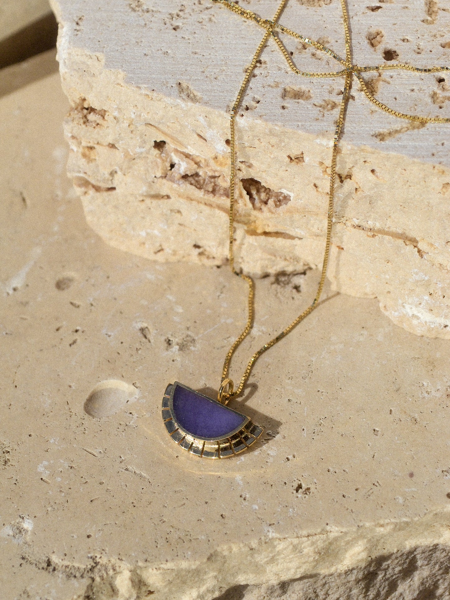 young in the mountains / A half circle of warm 14k yellow gold is wrapped around an inlaid Burro Creek Jasper stone while a serrated halo of light radiates from this sun. This pendant hangs freely on a 14k yellow gold box chain