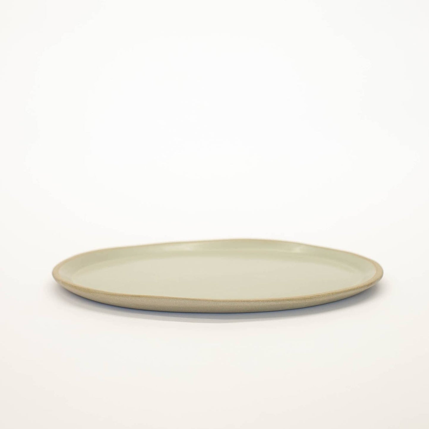 Hand-built with shallow walls, some organic quality around the rim, and a flat base, this ceramic platter is designed for serving. Use it as a charcuterie board, snack platter, coffee table tray, or your main course! Handmade in Virginia