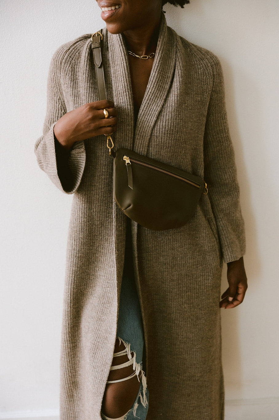 Fair trade and adjustable leather sling bag/fanny pack. Adjust the length to fit your needs. Handcrafted, vegetable tanned leather sling bag made in Kenya with locally and ethically-sourced materials. A portion of sales go to an organization in Tanzania empowering children living on the street.