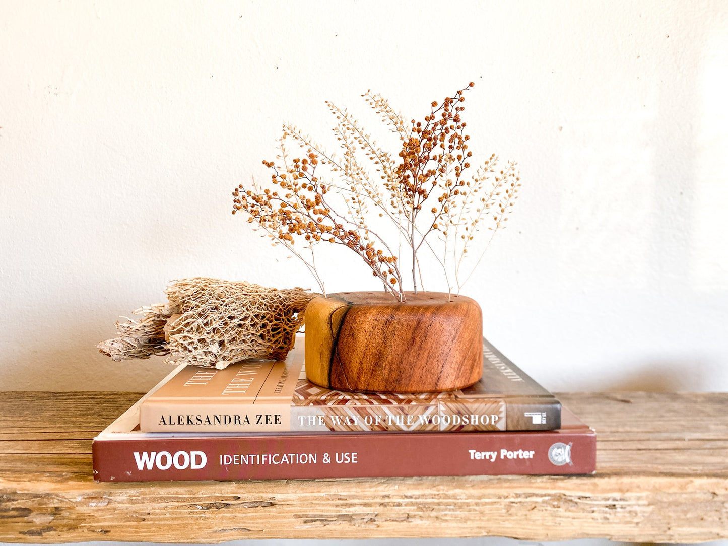 A wooden flower frog made from reclaimed mesquite. These were designed to provide a hint of warmth while giving you the creative play on height, color, texture and "flow" for your florals.