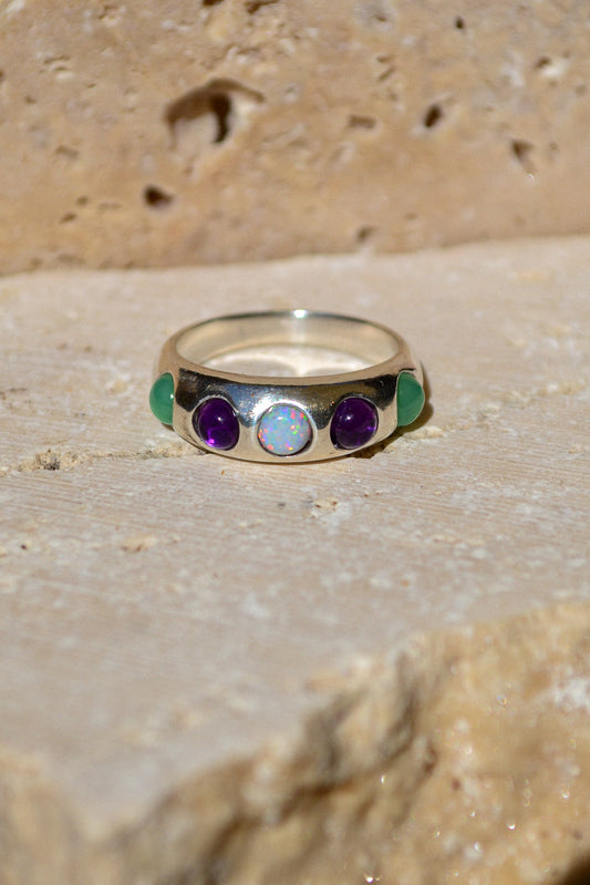 Bold and beautiful, the confetti ring is the life of the party. Featuring an assortment of genuine stones - teal chrysoprase, purple iolite, and sparkly opal