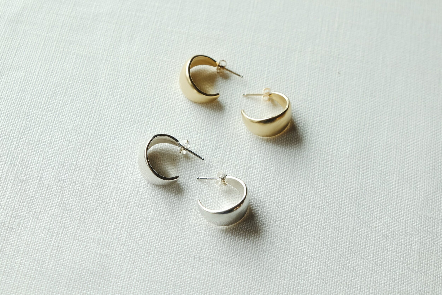 A chunky little everyday hoop. A bulb like round concave shape carved from wax and cast into metal. Handmade by Sarah Safavi.