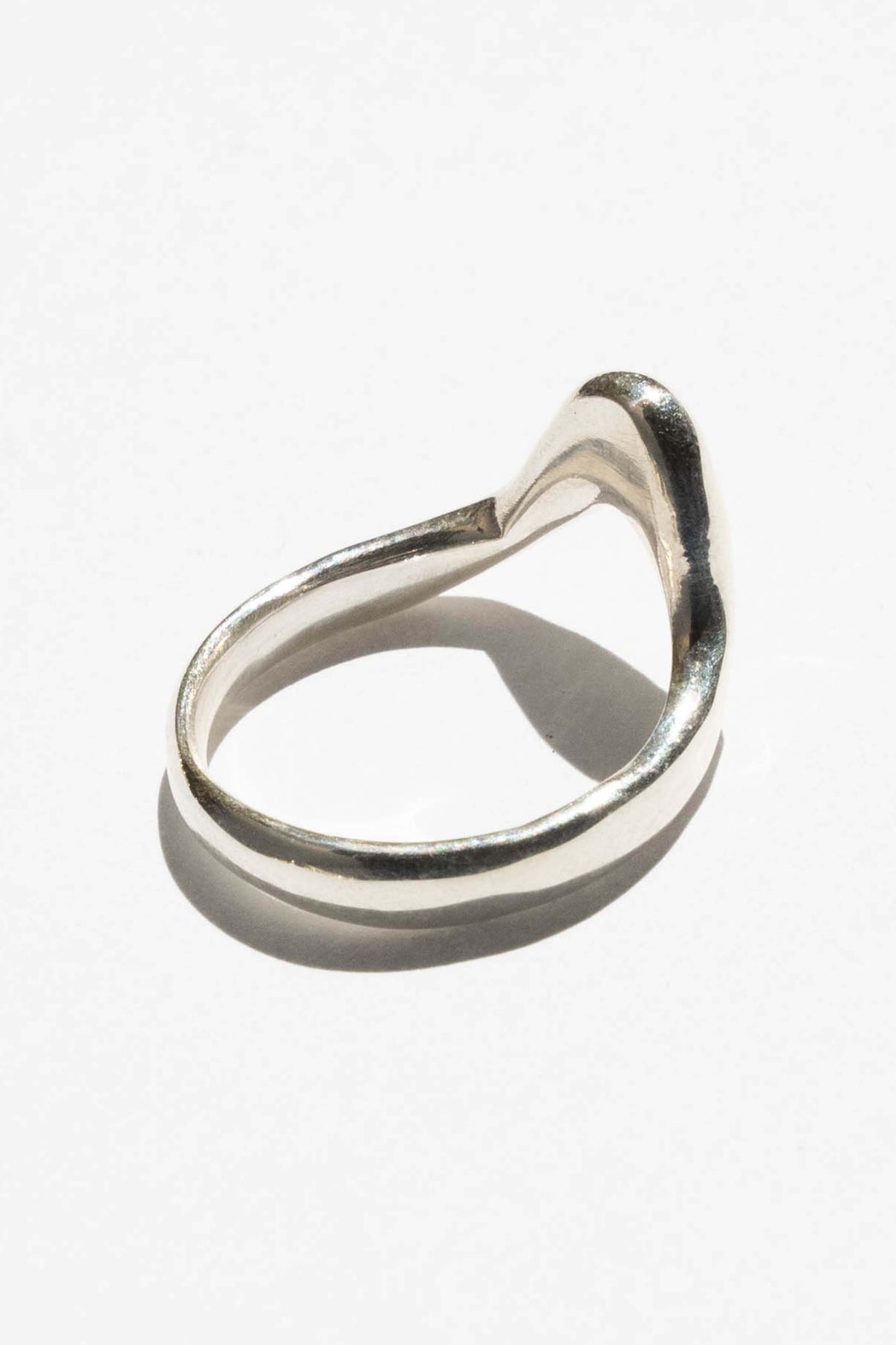 The High Tide ring is inspired by the movement of rising water. Hand carved and cast with a high polished mirror finish. Available in solid brass or sterling silver.