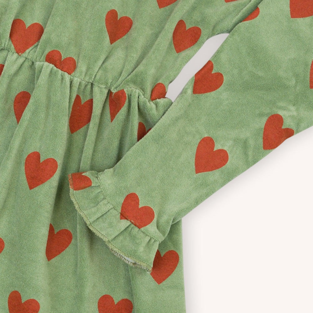 Green velvet long sleeved dress with a red heart print made with 95% organic cotton. Ethically produced, colorful and fun with an eye towards comfort, style and joy. Modern and sustainable kids clothing by CarlijnQ of the Netherlands.