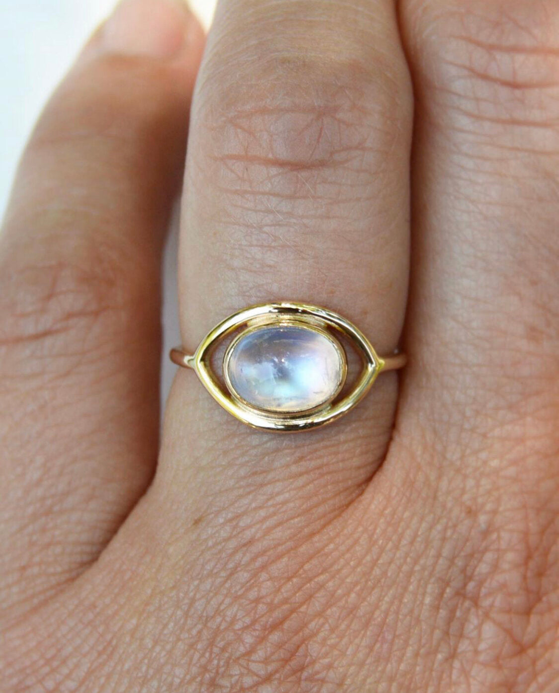 Made by hand in Northern New Mexico using recycled metals and responsibly sourced stones, this timeless, heirloom piece is sure to make a statement. This ring features a 14kt yellow gold 1.5 mm band with a moonstone cabochon.