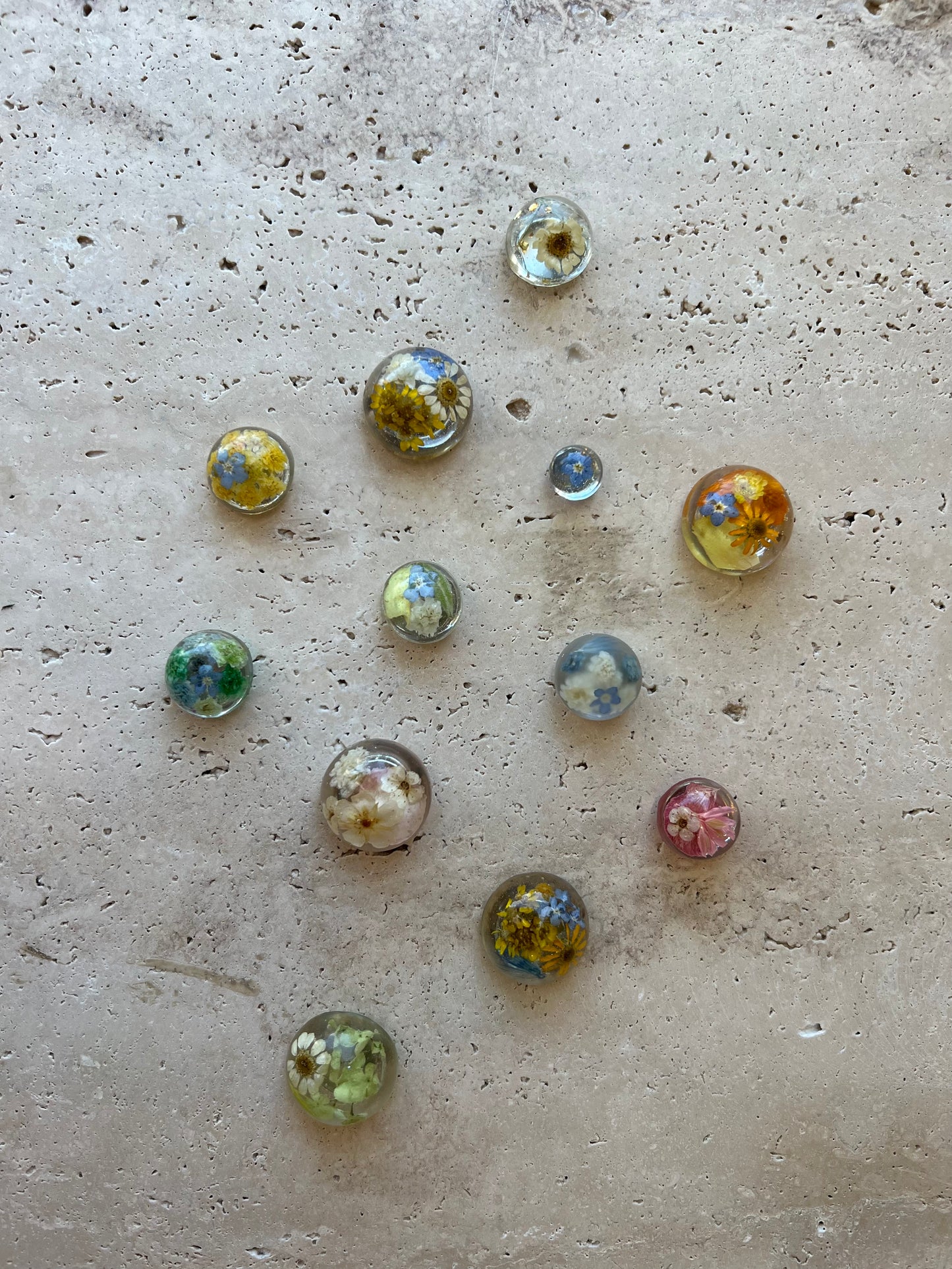 Functional art objects using hand-sourced, dried flowers encased in resin. Each piece is one of a kind and totally unique, made by hand in Lee Meszaros' home studio in Hamilton, Ontario.