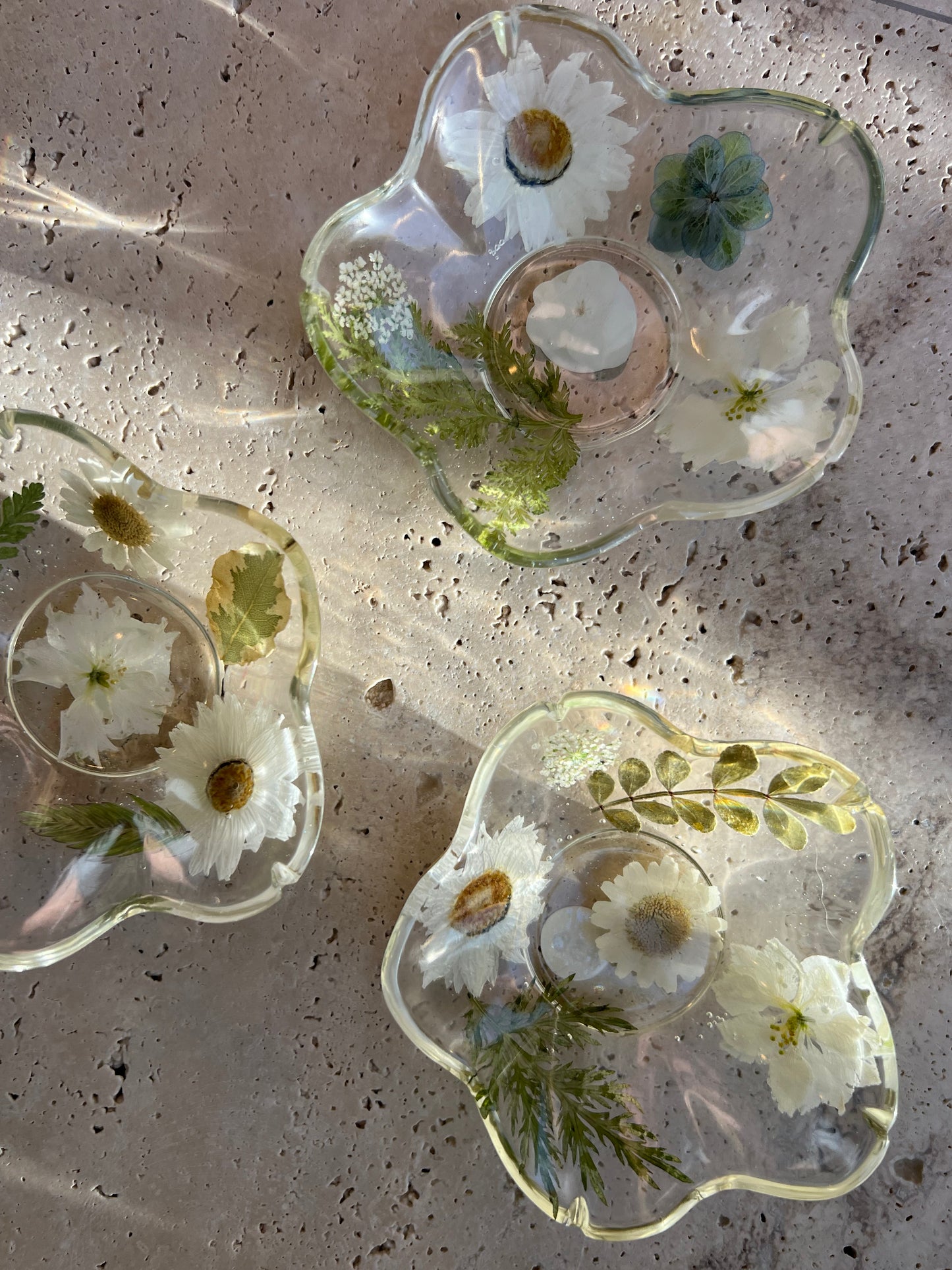 Functional art objects using hand-sourced, dried flowers encased in resin. Each piece is one of a kind and totally unique, made by hand in Lee Meszaros' home studio in Hamilton, Ontario.