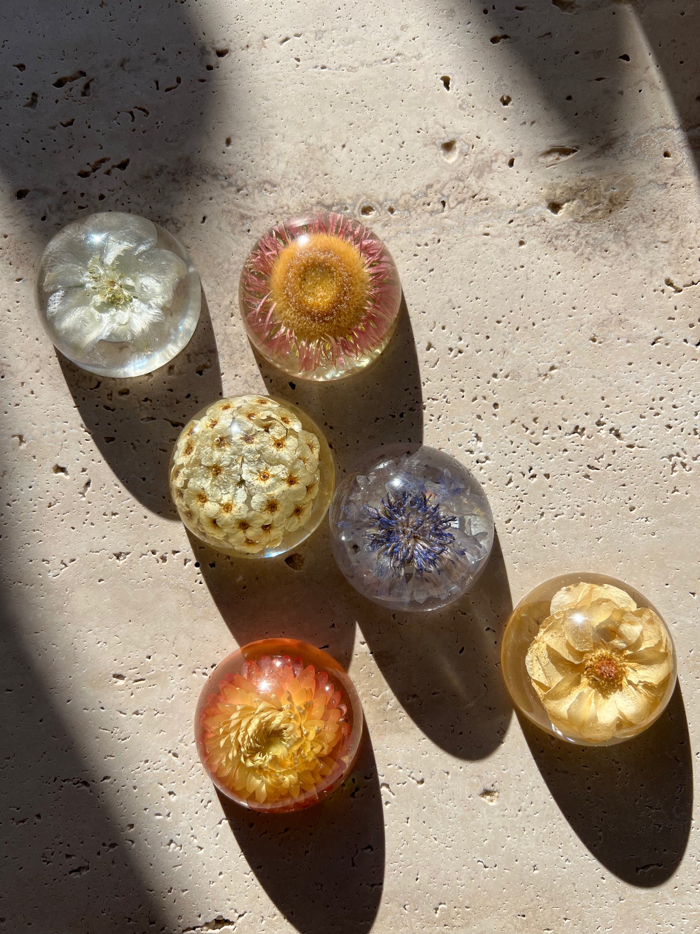 Functional art objects using hand-sourced, dried flowers encased in resin. Each piece is one of a kind and totally unique, made by hand in Lee Meszaros' home studio in Hamilton, Ontario.