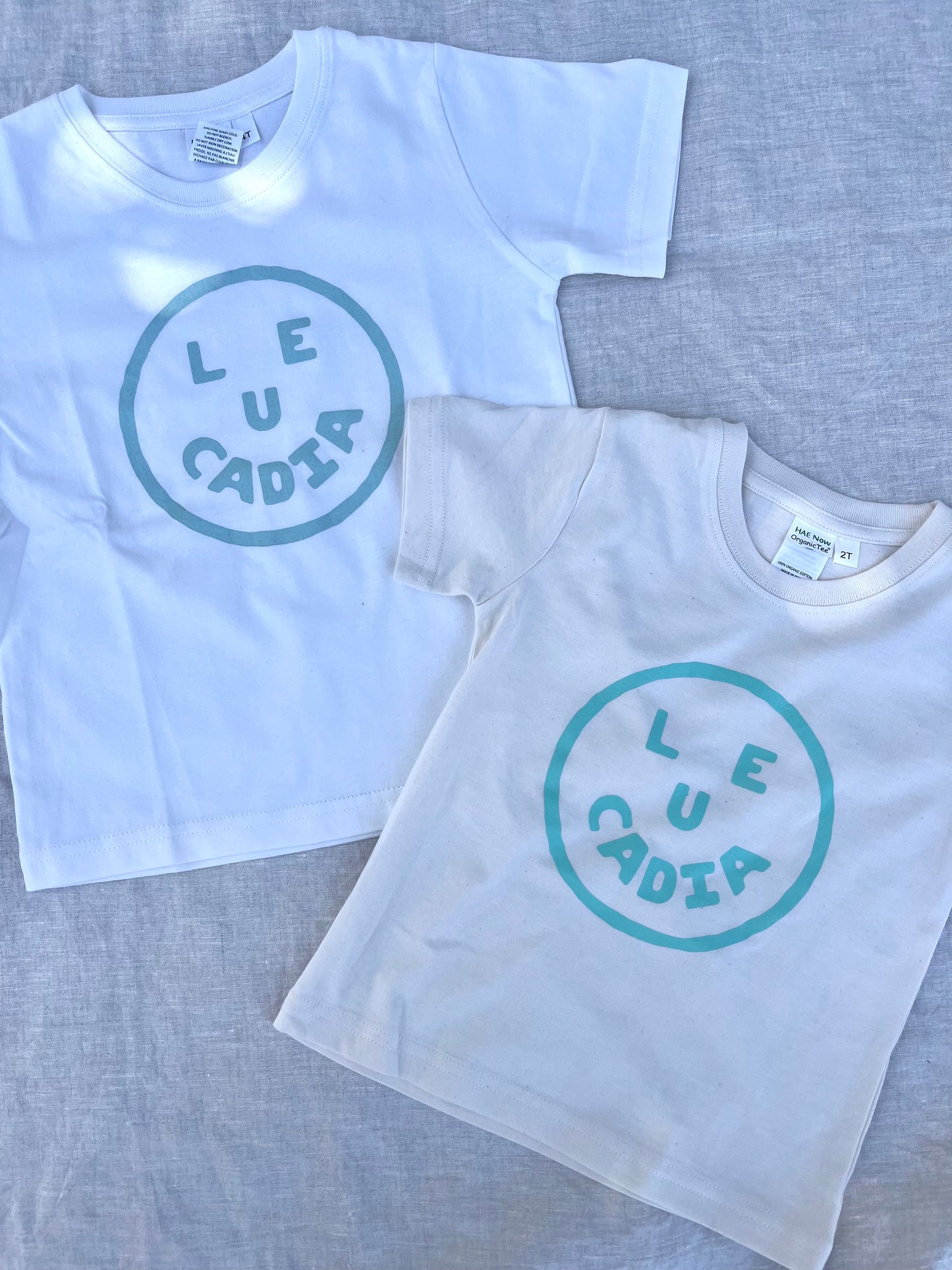 A fun little organic kids tee with a super cute little Leucadia smiley face by local artist Zach Smith. Printed on an organic cotton, fair trade tee with all proceeds to San Diego area families facing housing insecurity. Keep it funky, keep it kind, keep it local.