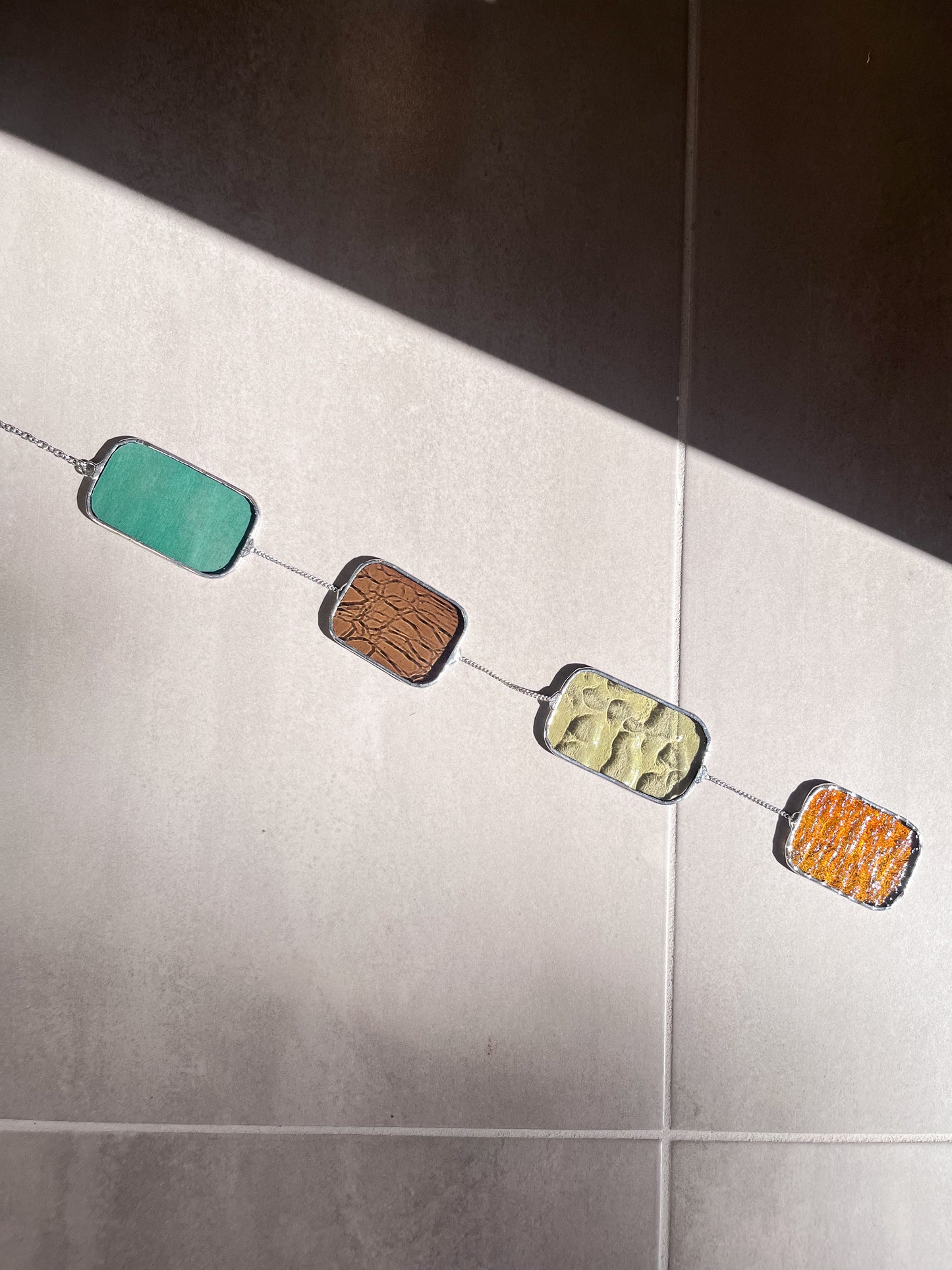 Handmade stained glass pendant with three elements attached by a silver chain. You can hang this panel in a window, on the wall as decor or even an outside patio. Custom made for Thread Spun by Culotta Creations.