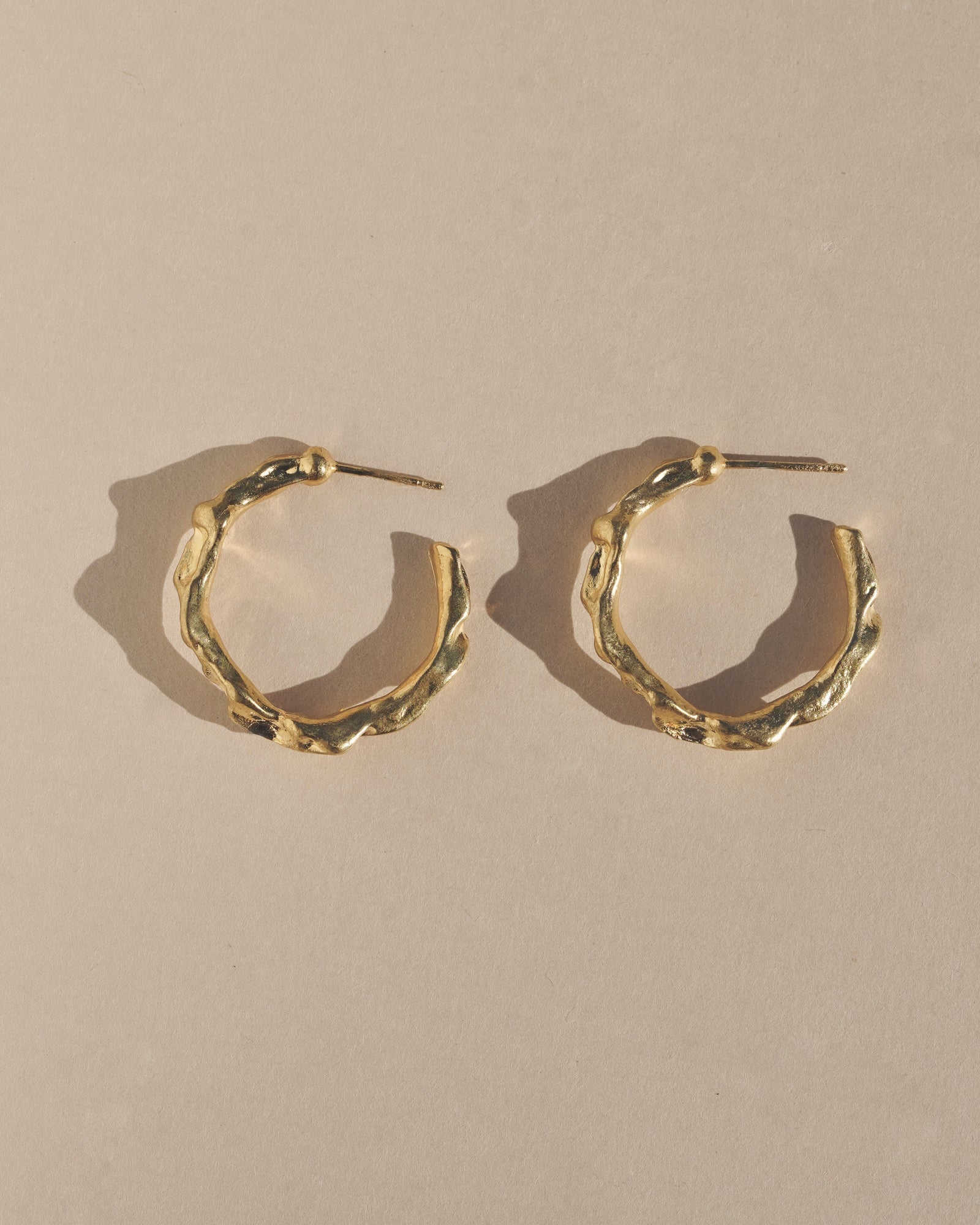 Edgy and modern with lots of texture, these hoops are beautiful and easy to wear. Fluid hoop earrings with wavy dimension in the perfect statement size.    Handmade in the Santa Cruz Mountains.