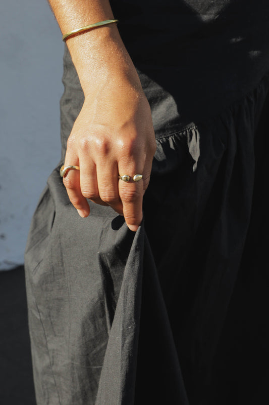 The Droplet ring is inspired by the round shape of falling rain. Hand carved and cast with a high polished mirror finish. Available in solid brass or sterling silver.