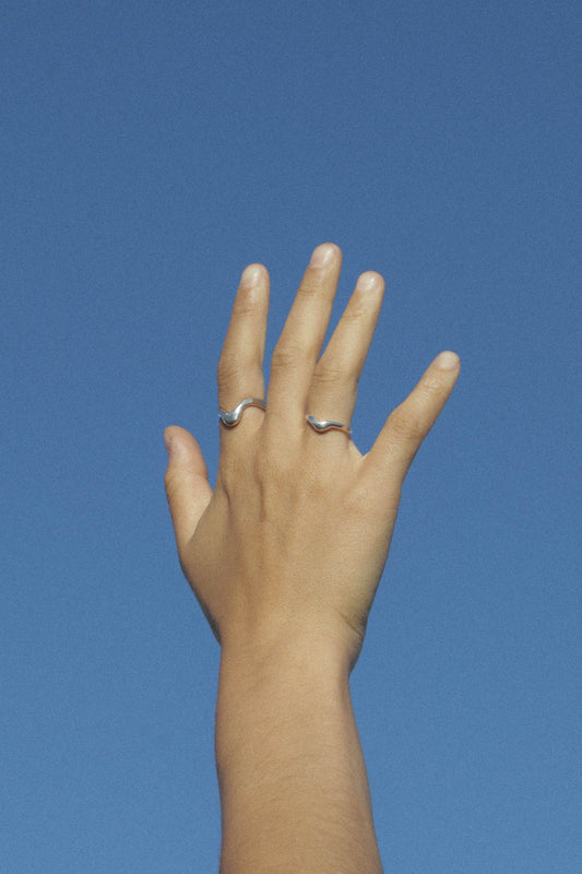 The High Tide ring is inspired by the movement of rising water. Hand carved and cast with a high polished mirror finish. Available in solid brass or sterling silver.