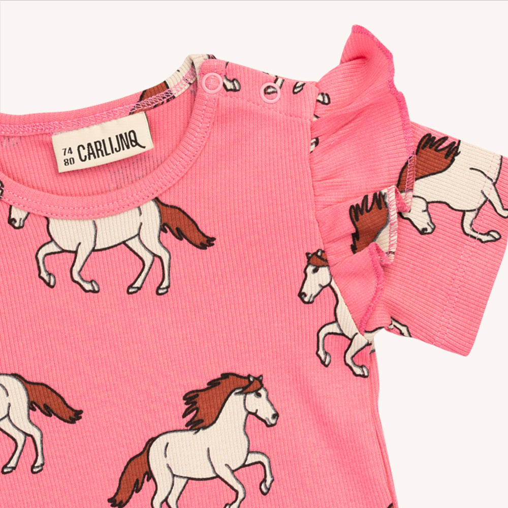 Pink based bodysuit with a horse print & ruffle shoulders. Made with 95% organic cotton. Ethically produced, colorful and fun with an eye towards comfort, style and joy. Modern and sustainable kids clothing by CarlijnQ of the Netherlands.