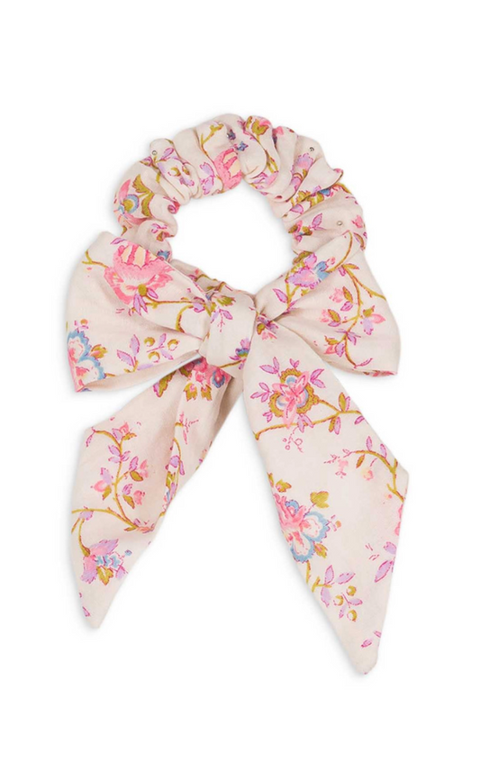 A floral hair scrunchie with a decorative bow. Made with 100% organic cotton. Louise Misha Akimmi Scrunchie.