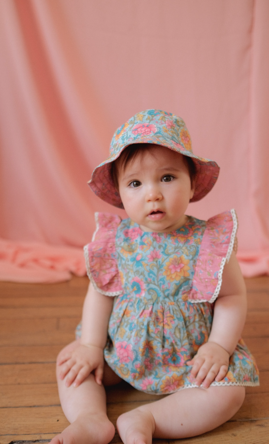 A reversible summer sun hat with a different print on each side. Made with 100% organic cotton. Louise misha lajik sun hat in water river flowers.