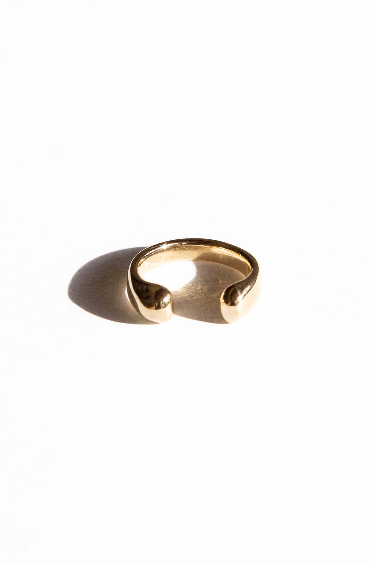 The Droplet ring is inspired by the round shape of falling rain. Hand carved and cast with a high polished mirror finish. Available in solid brass or sterling silver.