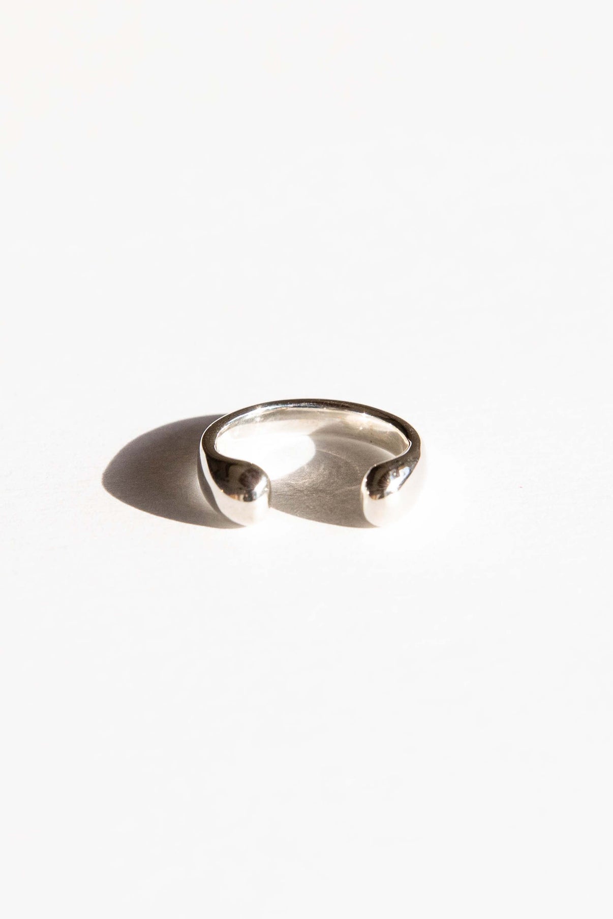 The Droplet ring is inspired by the round shape of falling rain. Hand carved and cast with a high polished mirror finish. Available in solid brass or sterling silver.