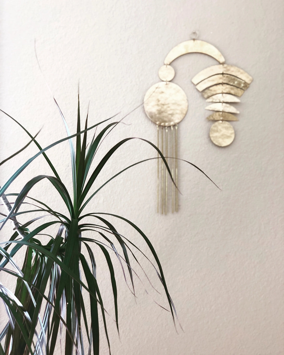 Artisan-crafted wall hanging made from hand-cut and hammered brass sheet and tubing. Ready to hang in any space in your home.