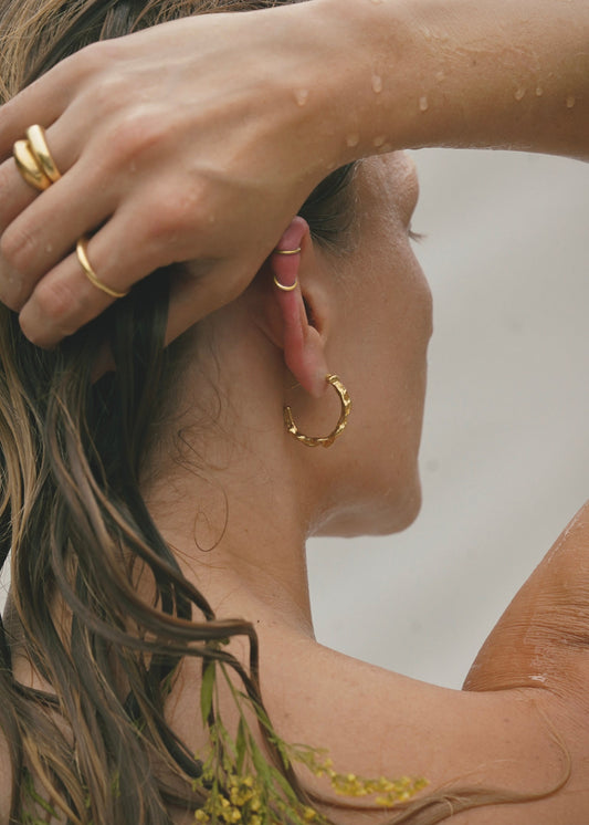 Edgy and modern with lots of texture, these hoops are beautiful and easy to wear. Fluid hoop earrings with wavy dimension in the perfect statement size. Handmade in the Santa Cruz Mountains.