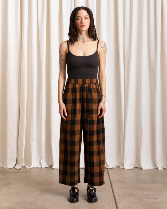 ali golden / An elastic waist pant in raw silk with poppy/pink plaid pattern and barrel pant silhouette.