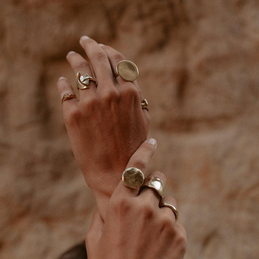 dea dia artemis moon & heart ring / Paying homage to the goddess of the hunt and the moon, Artemis, this meticulously handmade piece showcases delightful texture and shine. Its adjustable design, adorned with crescent moon and heart motifs, renders a timeless charm with a hint of whimsy. Handmade with recycled brass in Downtown Los Angeles.