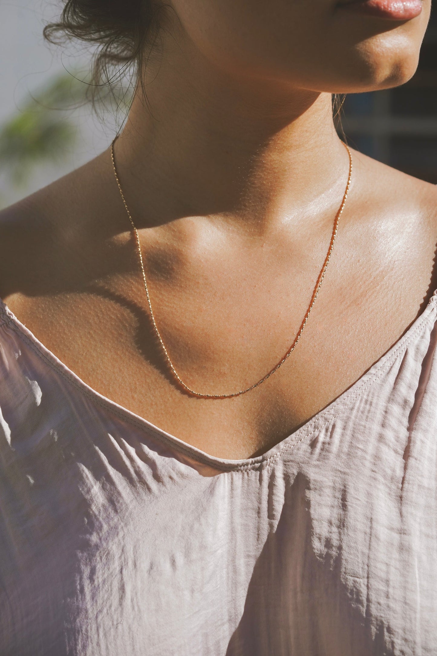 A long delicate sparkling twisted style that catches the light and glimmers across the neckline adding that extra touch of golden warmth, a perfect layering piece or simple statement on it's own. Handmade in the Santa Cruz Mountains.