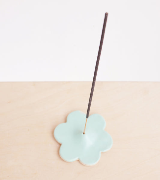 Modern, minimalist incense holder in a simple floral design. A bright satin glaze finishes the piece.