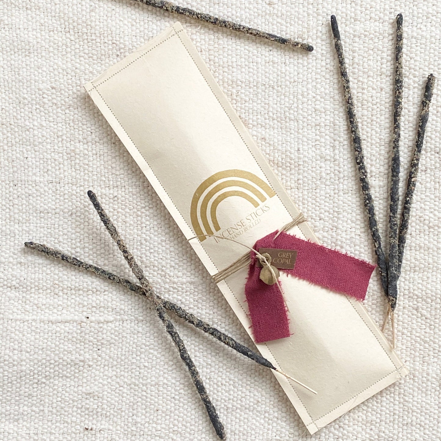 Pack of 12 hand rolled, copal resin incense sticks Each pack is wrapped with hemp, vintage fabric, and a brass bell.