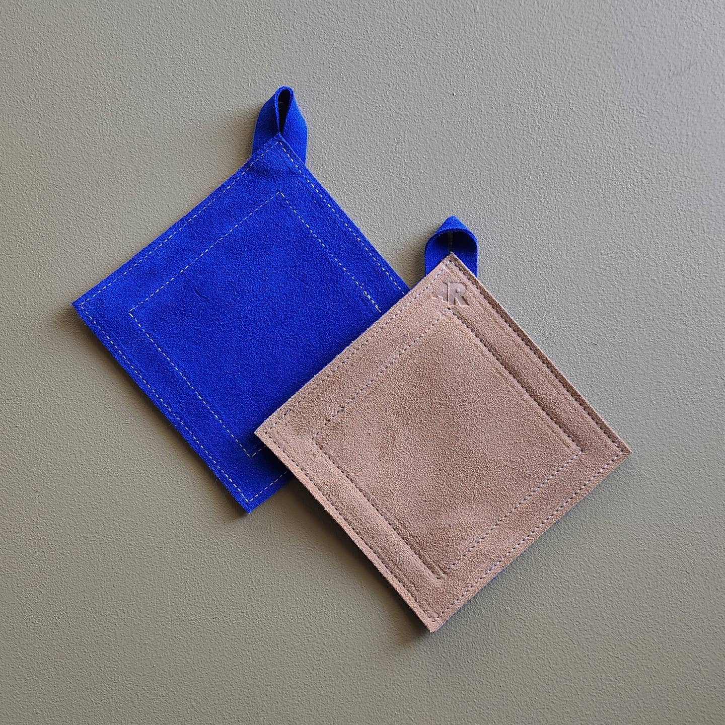 Double-sided suede potholder with loop.