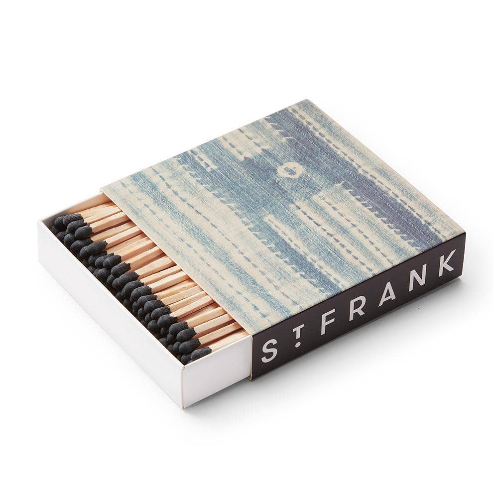 This matchbox is printed with a replica of a vintage Kuba cloth, a unique textile featuring complex designs that are created when various geometric raffia pieces are stitched to a plain raffia background. Matchbox is made from printed paper and filled with approximately 120 3.75" safety matches.