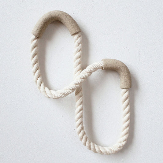 These “noodles” are the continuation of a series of wall sculptures by Janelle Gramling where she pairs ceramic tubes with cotton rope in a playful exploration of form and material.