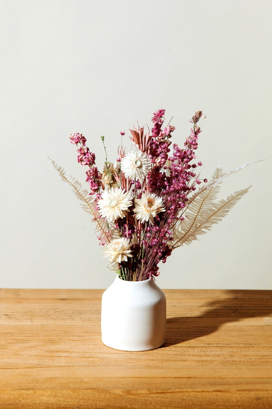 This dried bouquet is carefully arranged by a team of designers in Idlewild Floral Co's California studio, and are made of beautifully preserved long lasting flowers. Perfect paired with a bud vase or as a gift for any occasion. Each bouquet is 12"-14" long x 4"-6" wide.