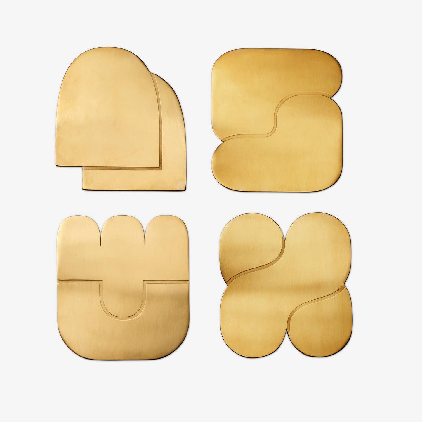 areaware together coasters / Set of four brass-plated coasters uses abstract, interlocking shapes to signify connection and togetherness. The weightiness of the brass ensures none of those sticking-to-your-cup situations when picked up, & designed to protect your surfaces from watermarks and scratches.