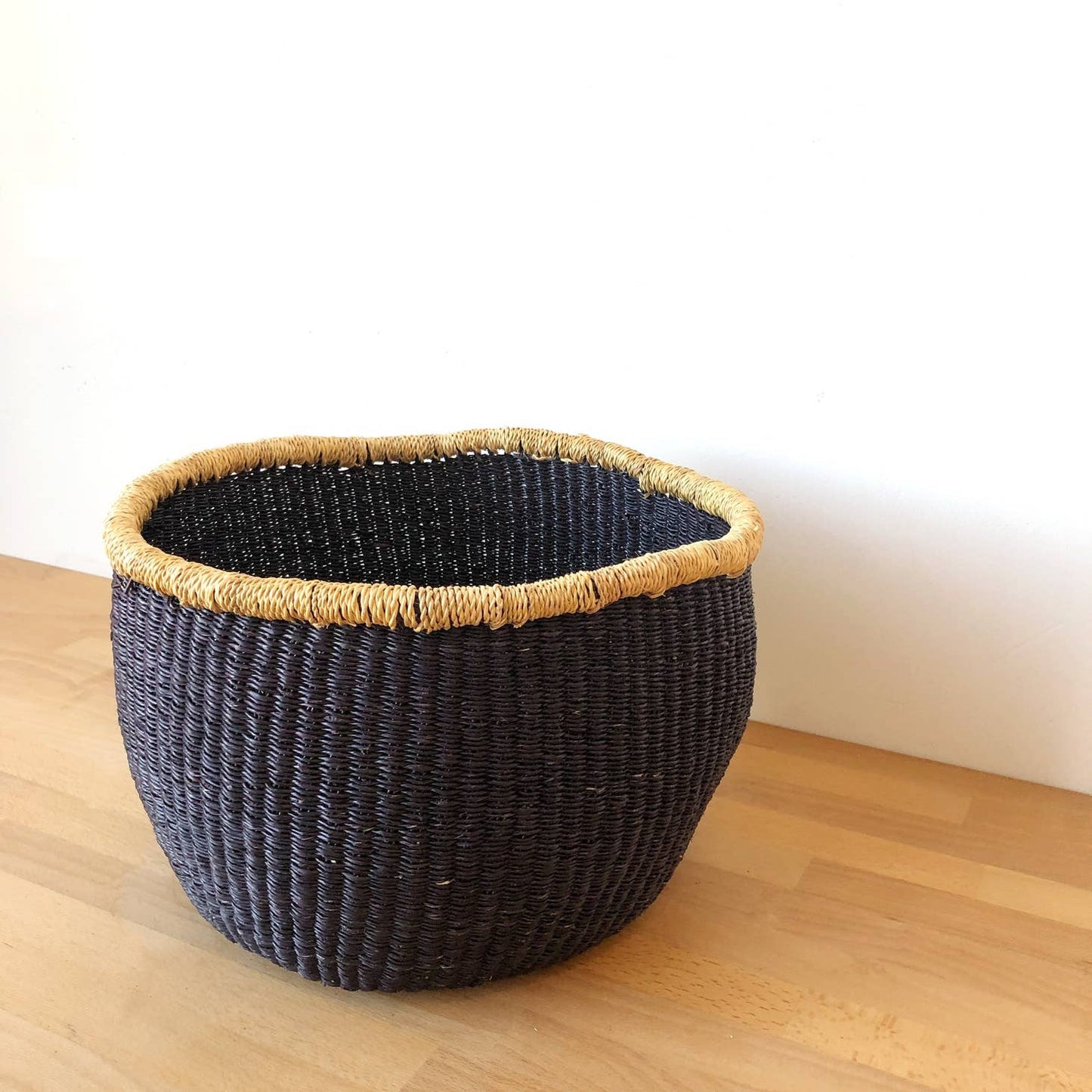 This storage basket is great for holding blankets, toys, knitting supplies and other things.  It is handwoven from veta vera grass in northern Ghana. The grass is dried, split, rolled, and dyed, before being woven into this beautiful work of art.