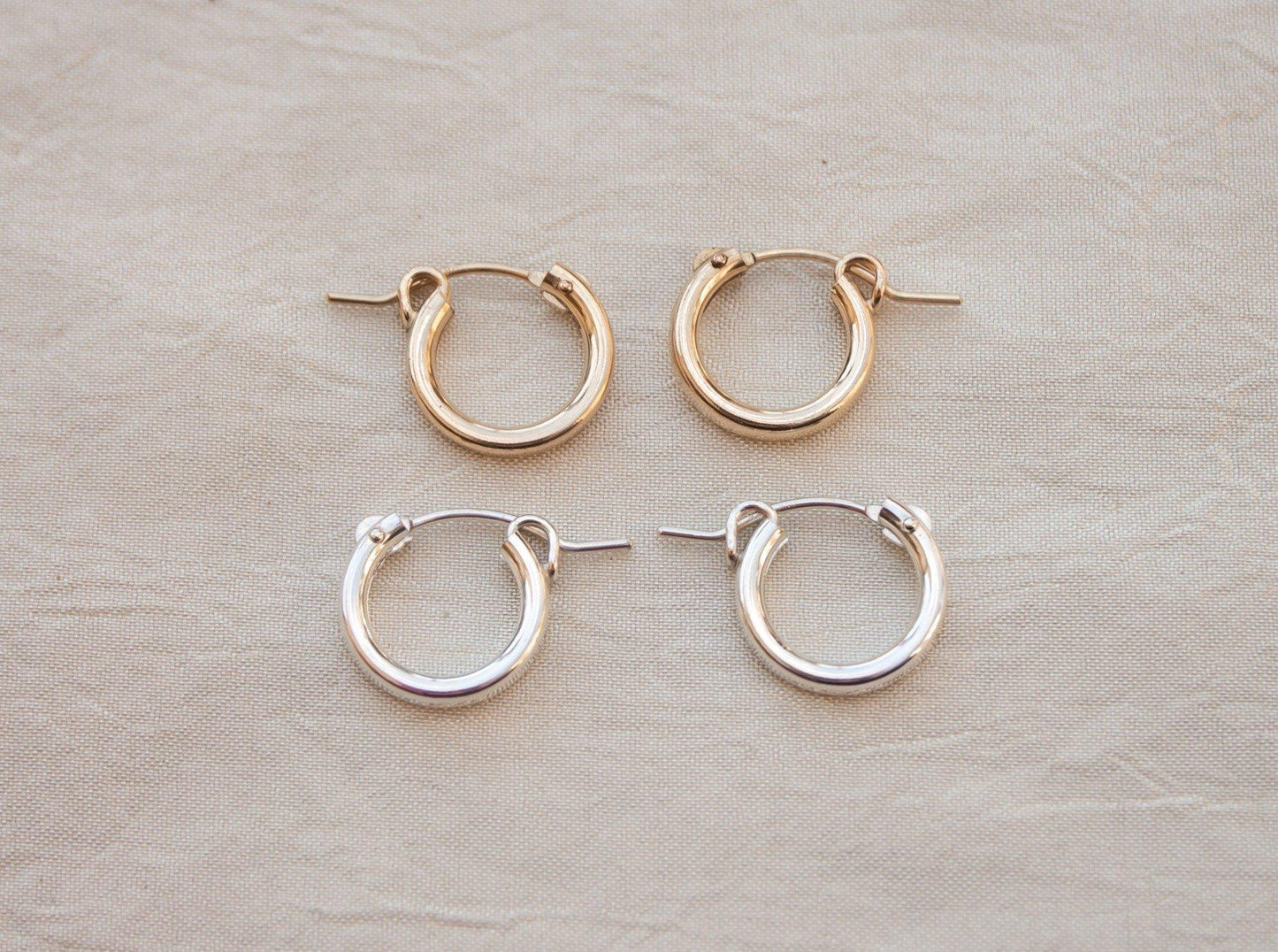 Click hoop earrings might be basic, but never boring. Just the right size to put them in and forget about them but still manage to look put together, a total win! Sterling silver or gold fill, featuring hollow tubes with click-close mechanism. Designed and handmade in Los Angeles.