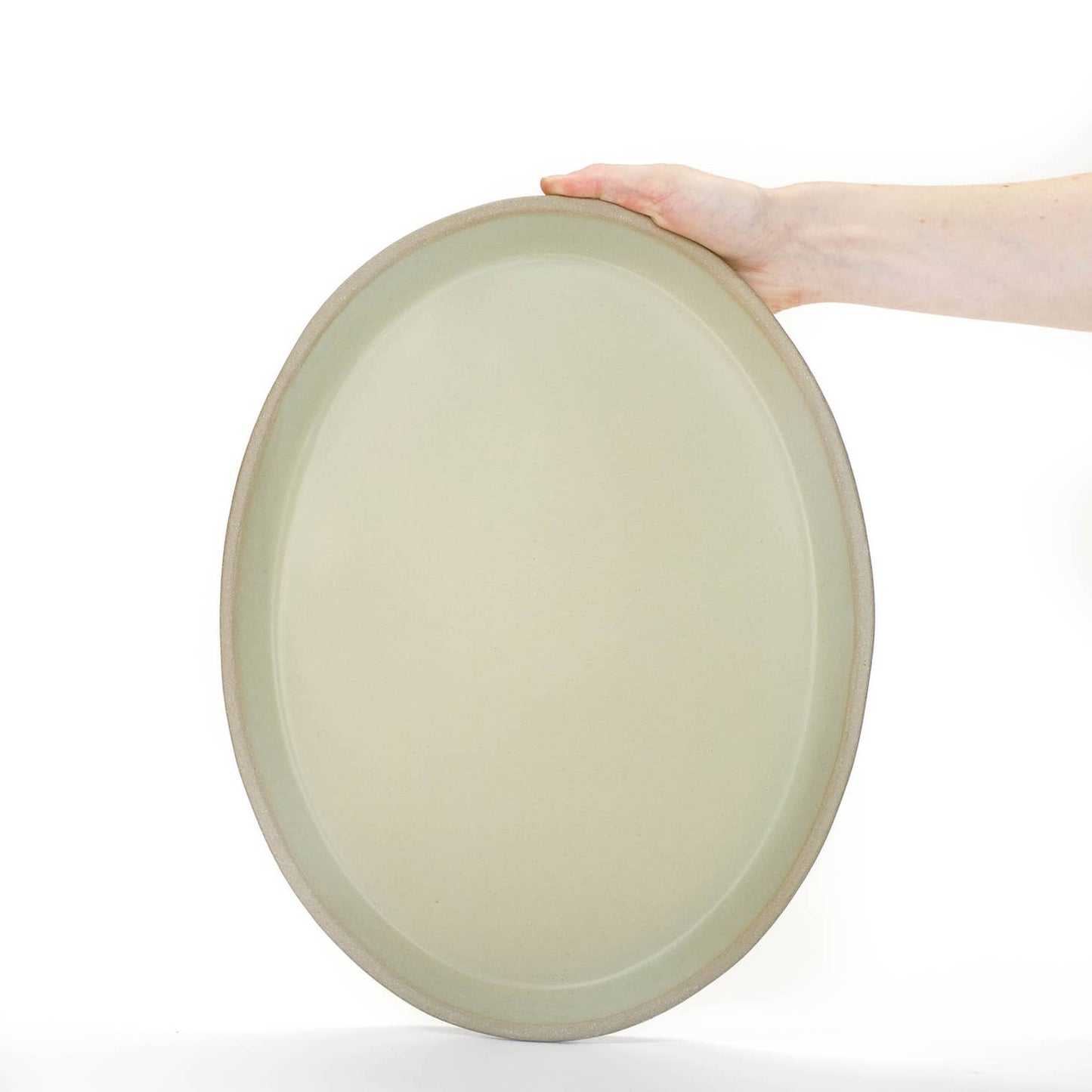 Hand-built with shallow walls, some organic quality around the rim, and a flat base, this ceramic platter is designed for serving. Use it as a charcuterie board, snack platter, coffee table tray, or your main course! Handmade in Virginia