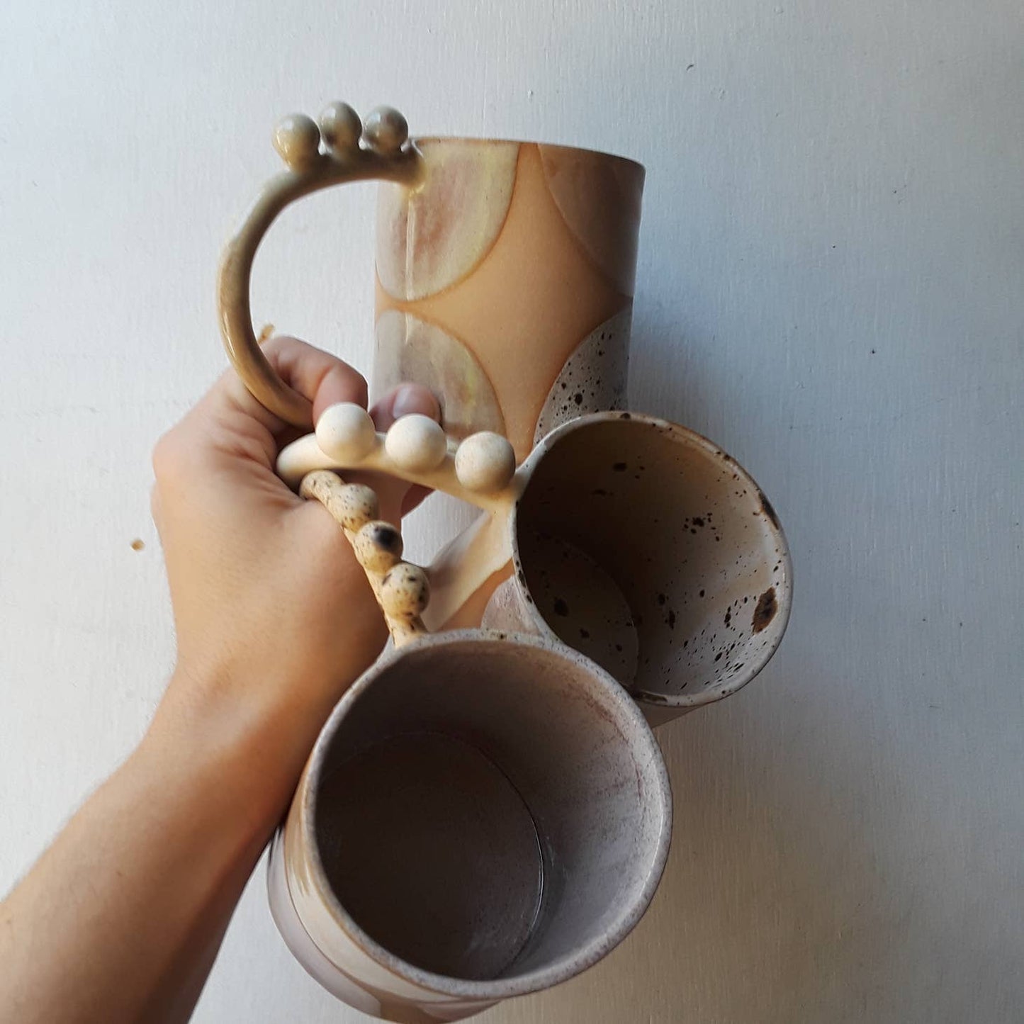 Handmade ceramic mug featuring unique glaze colors & ball accents atop a looped handle. Each is entirely one of a kind, all including gold luster to help you shine all day long. Handmade by Curious Clay in Virginia.